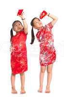 Asian girls peeking into red packet
