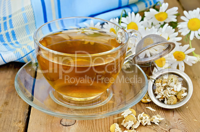 herbal chamomile tea with a strainer and a glass cup