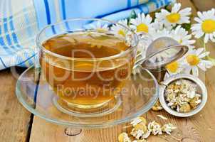 herbal chamomile tea with a strainer and a glass cup