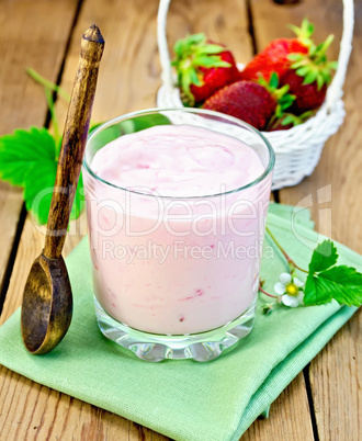 milkshake with strawberries and spoon on the board