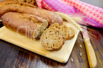 rye baguettes with a knife and a wicker basket