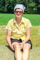 Peasant woman sitting on the hay bale