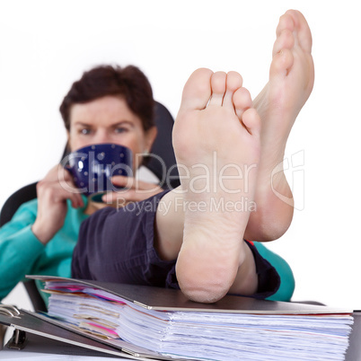 Office woman puts feet up relaxing