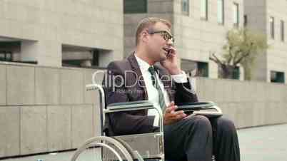 4of15 Health and handicap, business people on wheelchair outdoors