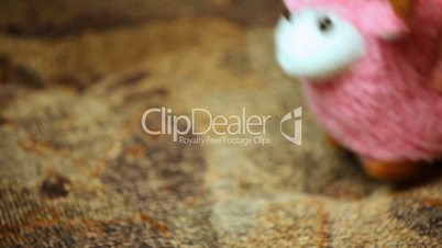 woman's hand playing toy pink sheep