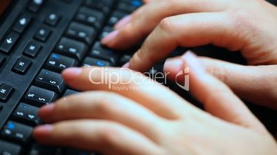 female hands print text on black keyboard