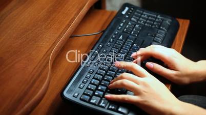 female hands print text on black keyboard