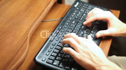 man's hands print text on black keyboard