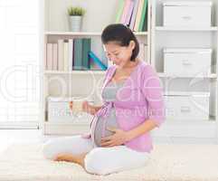 Pregnant woman drinking soymilk