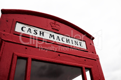 red telephone booth converted to cash machine
