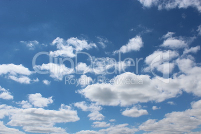 picturesque white clouds on blue sky background