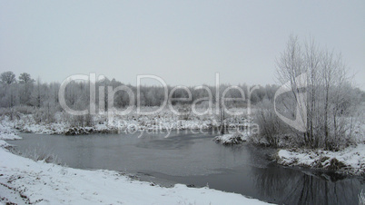 winter landscape with unfrozen river and snow