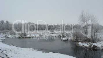 winter landscape with unfrozen river and snow