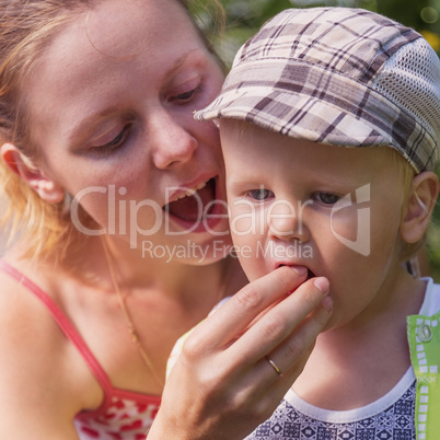 mum feeds the little boy