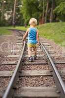 the little boy goes on railroad tracks