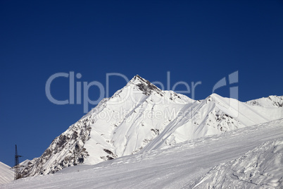 ski slope and blue clear sky at sunny day