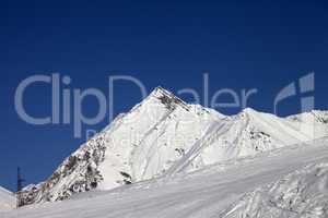ski slope and blue clear sky at sunny day