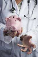 Doctor In Handcuffs Holding Piggy Bank Wearing Lab Coat, Stethos