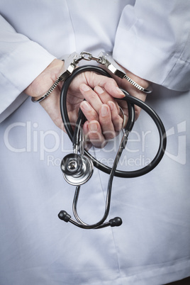 Female Doctor or Nurse In Handcuffs Holding Stethoscope