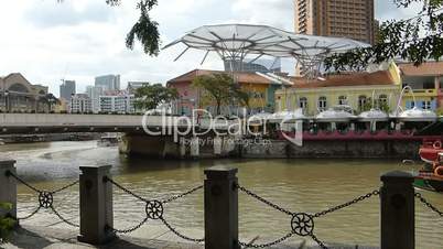 Sightseeing bumboat cruising on Singapore River.