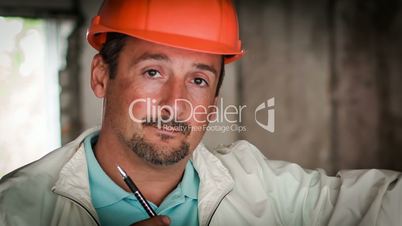 the engineer-builder thinks on the object. close-up raw video