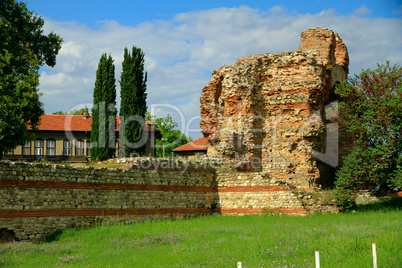 ancient ruins on the background of modern buildings in the city