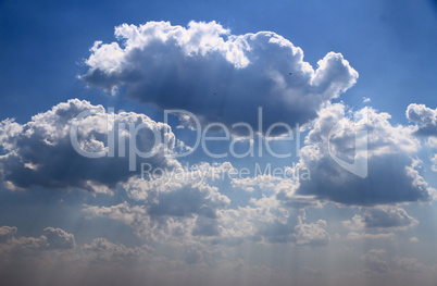 bright blue sky with puffy white clouds.