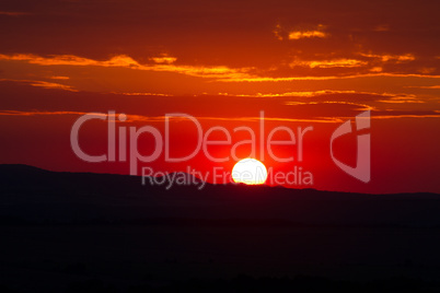 the red sunset sky with the sun and clouds