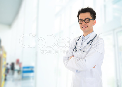 Asian doctor standing at hospital corridor