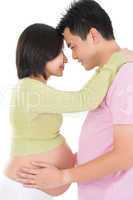 Asian pregnant couple face to face