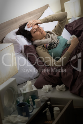 Sick woman with flu lying in bed