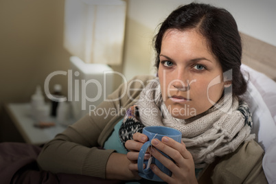 Woman having cold sore throat drinking tea