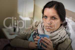 Woman having cold sore throat drinking tea