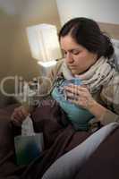 Sick woman with flu, tissue and tea