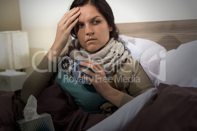 Young woman in bed having flu
