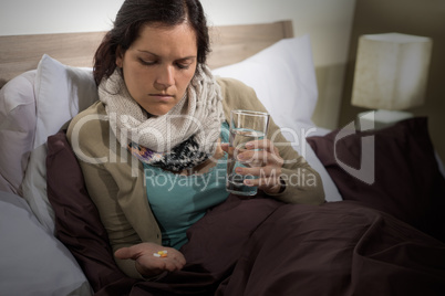 Young sick woman hold medicine pills