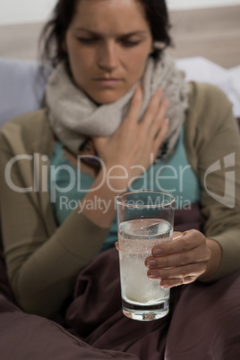 Sick woman preparing cold medicine to drink