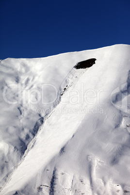 trace of avalanche on off piste slope in sun day