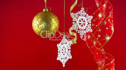 Golden ball, snowflakes and red ribbons