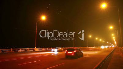 Timelapse of traffic on bridge at night