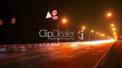 Timelapse of traffic on bridge at night