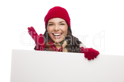 Thrilled Girl Wearing Winter Hat and Gloves Holds Blank Sign