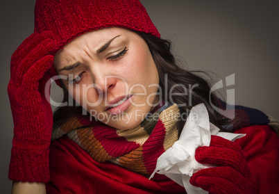 Miserable Mixed Race Woman Blowing Her Sore Nose with Tissue