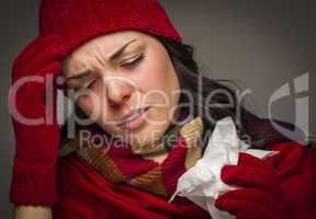 Miserable Mixed Race Woman Blowing Her Sore Nose with Tissue