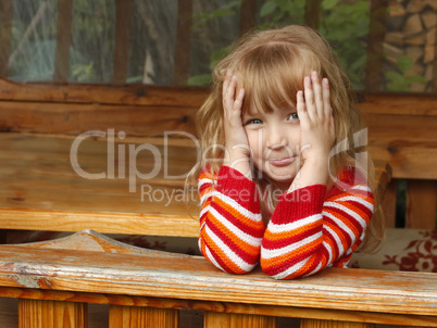 Little girl in wooden canopy outdoor