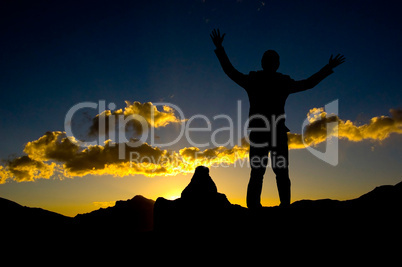 Silhouette of businessman standing on top mountaint