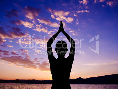 Silhouette yoga prayer pose