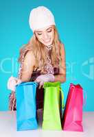 delighted woman peeking into her shopping bags