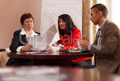 businesspeople having a meeting over coffee