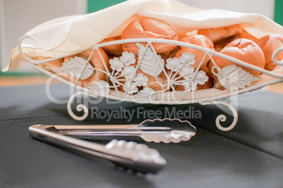 tasty rolls lying on a white napkin in a basket